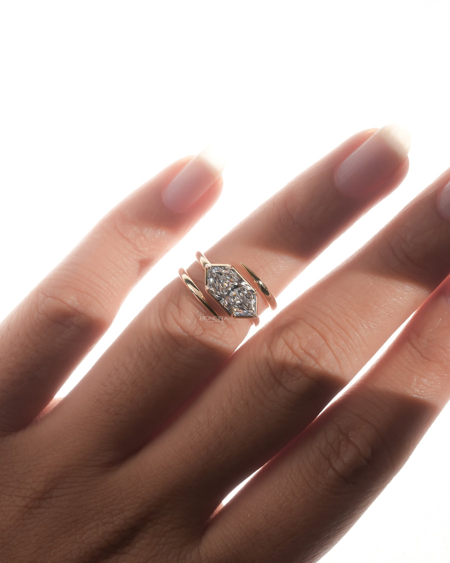 Dutch marquise lab grown diamond ring in rose gold worn on a finger, east west bezel setting with bypass band