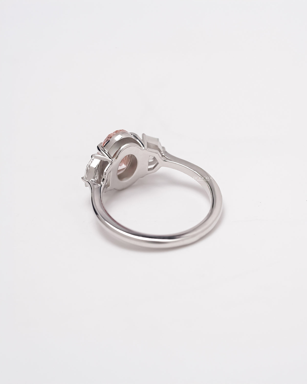 Back view of pink lab grown diamond three-stone ring showing band and gallery detail
