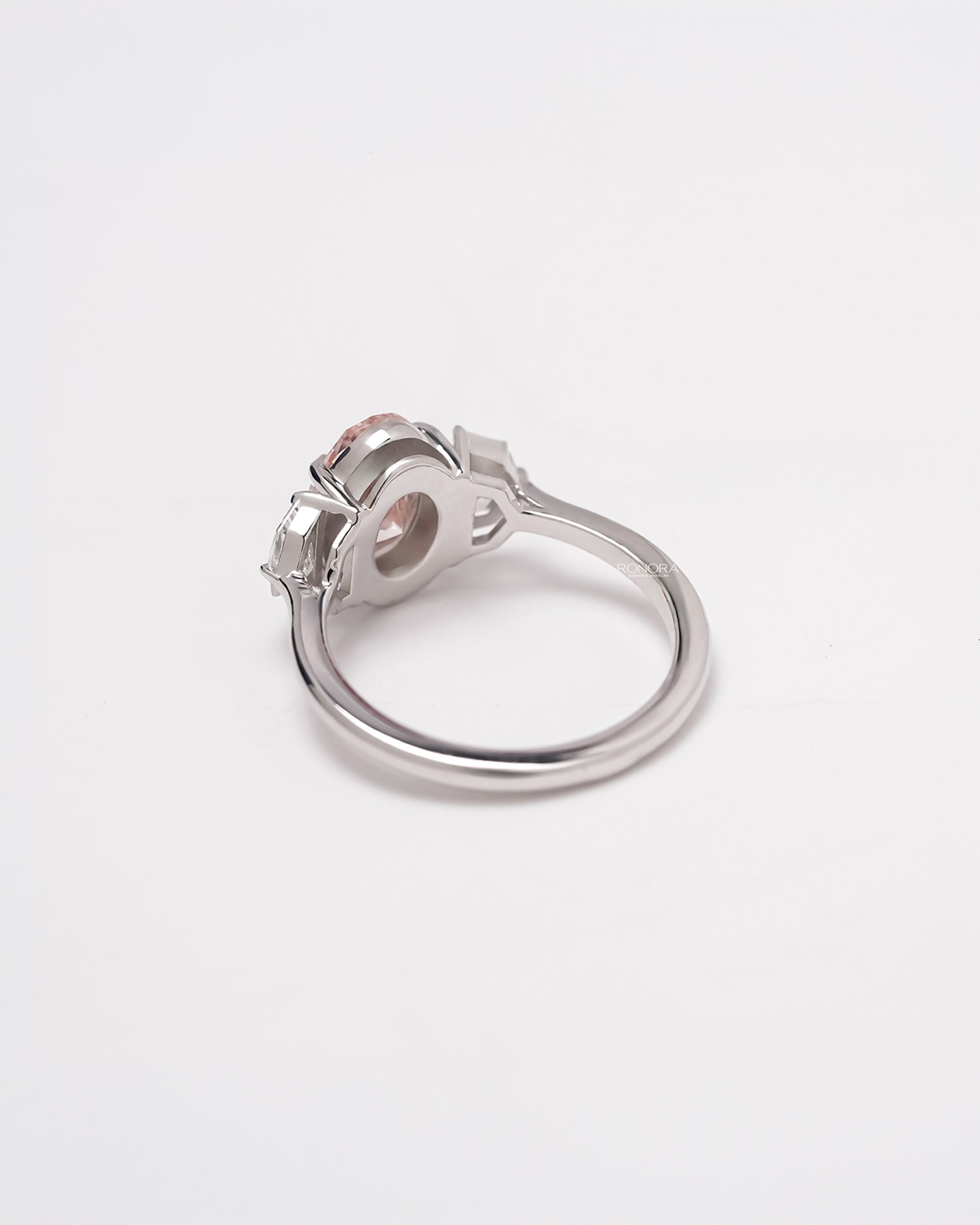 Back view of pink lab grown diamond three-stone ring showing band and gallery detail
