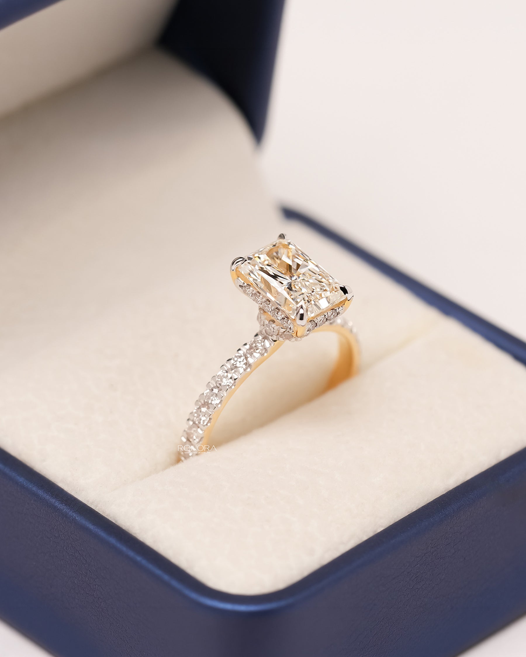 Angled view of radiant lab grown diamond pavé ring showing pavé setting