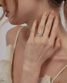 Model wearing a marquise lab grown diamond bypass ring in rose gold, hand resting against her neck