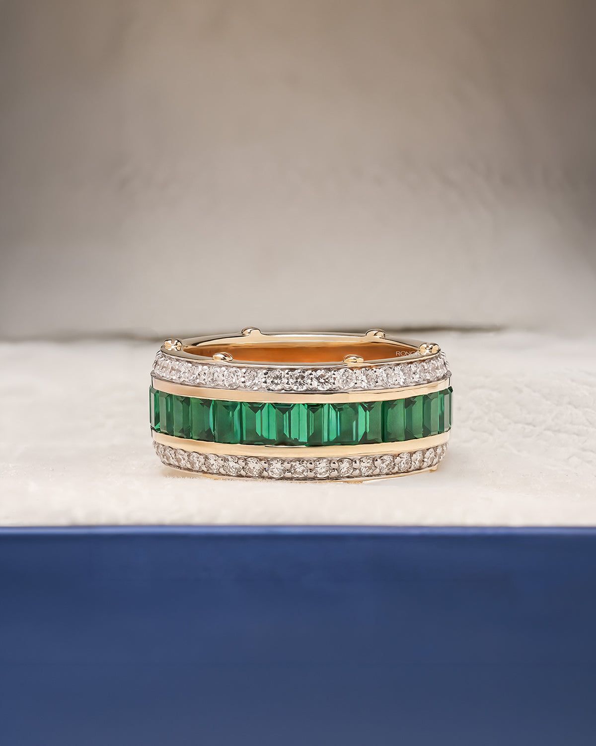 Emerelle green lab grown diamond channel band in yellow gold inside Ronora box