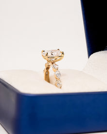 Angled view of oval lab grown diamond side-stone ring showing side-stone setting