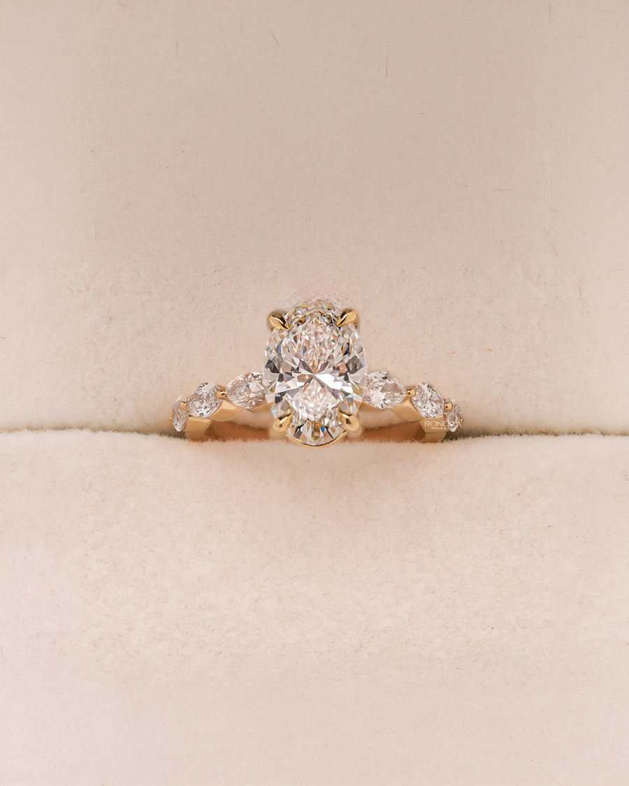 Celeste oval lab grown diamond side-stone ring in yellow gold inside Ronora box