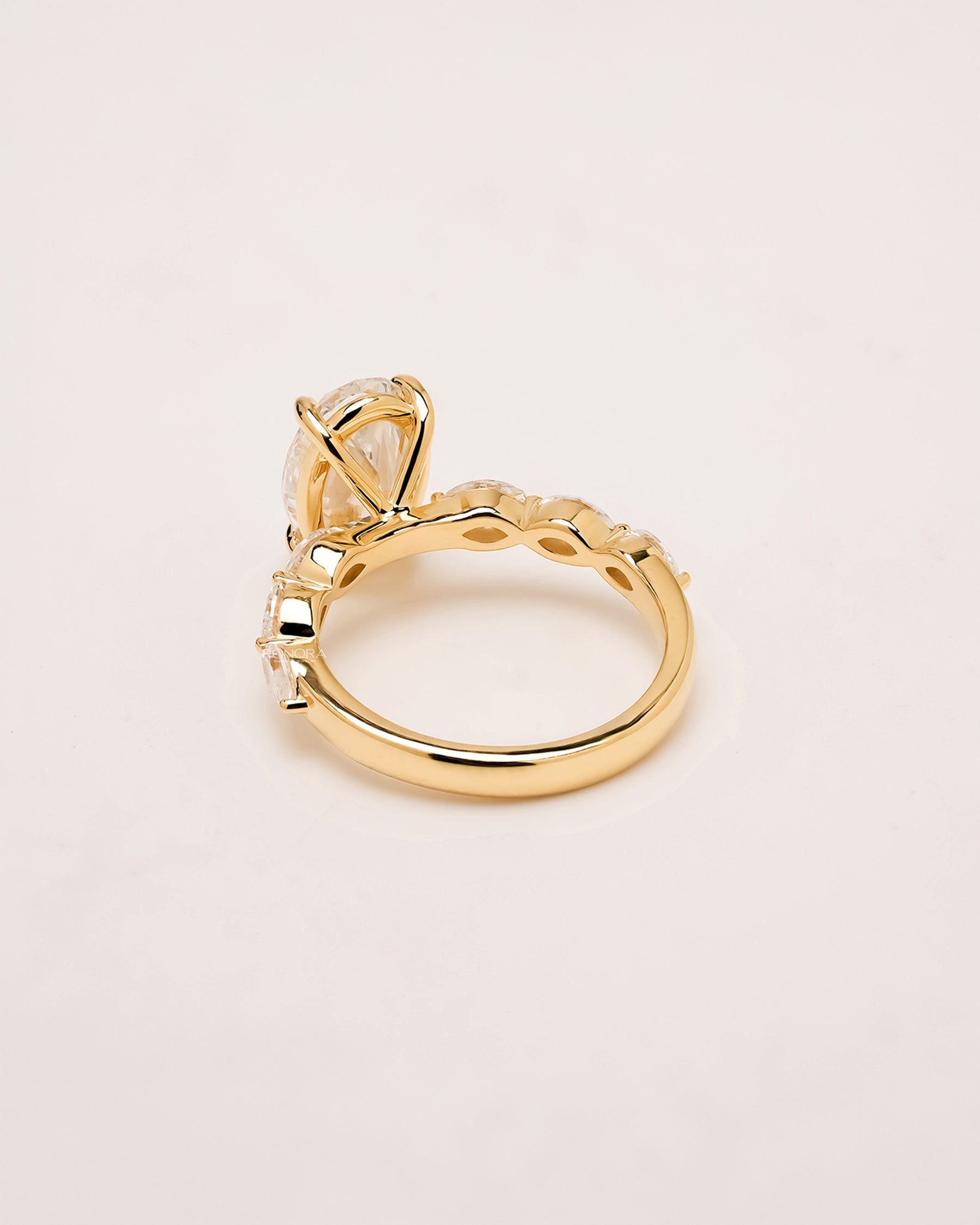 Side profile of oval lab grown diamond side-stone ring showing side-stone setting