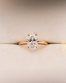 Noelle oval lab grown diamond solitaire ring in yellow gold inside Ronora box