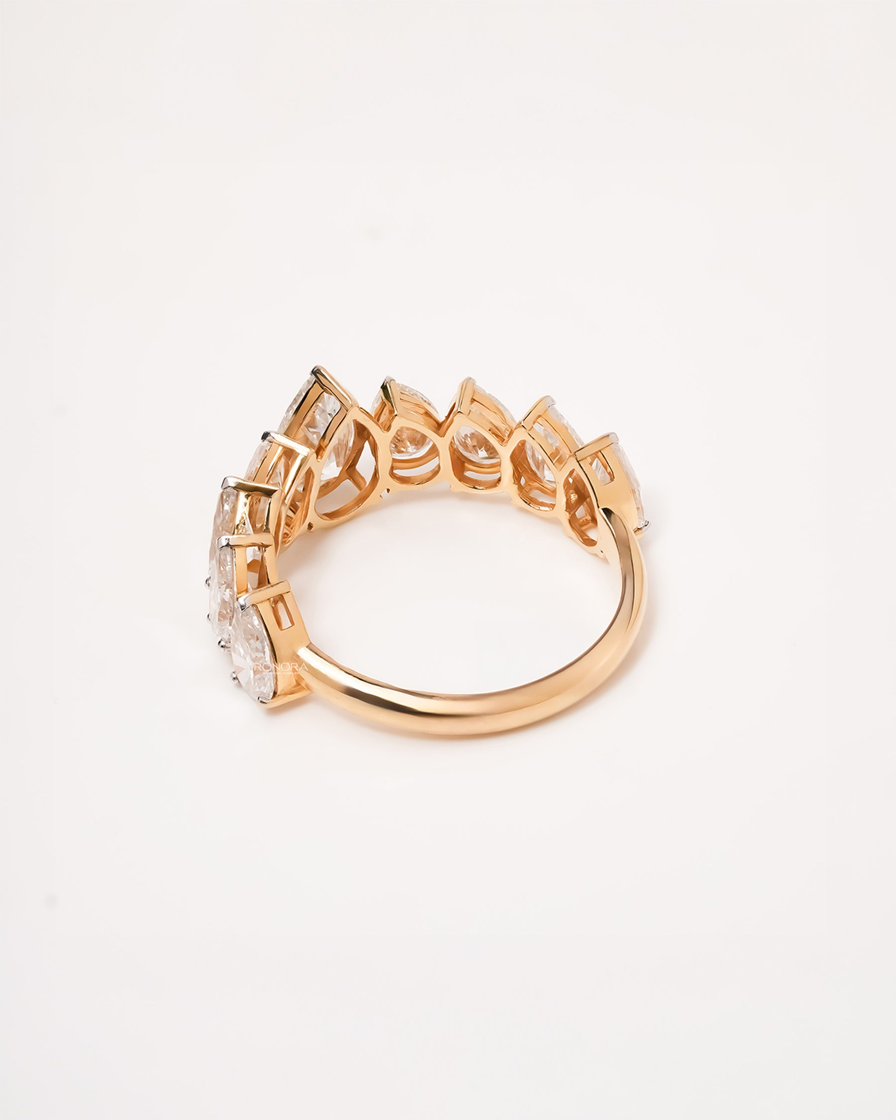 Side profile of pear lab grown diamond five-stone band showing graduated shared-prong setting
