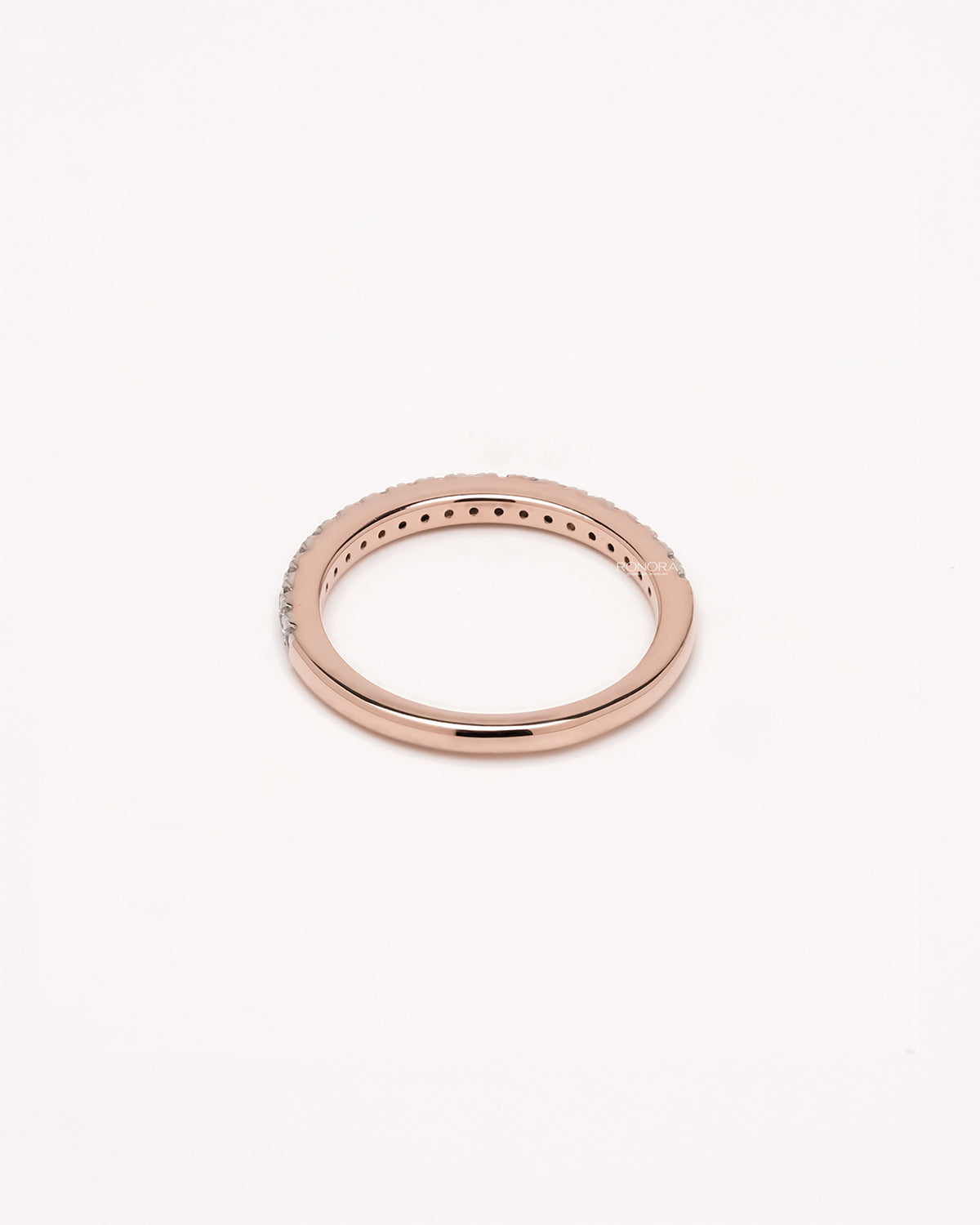 Side profile of slim curved lab grown diamond pavé band showing pavé setting