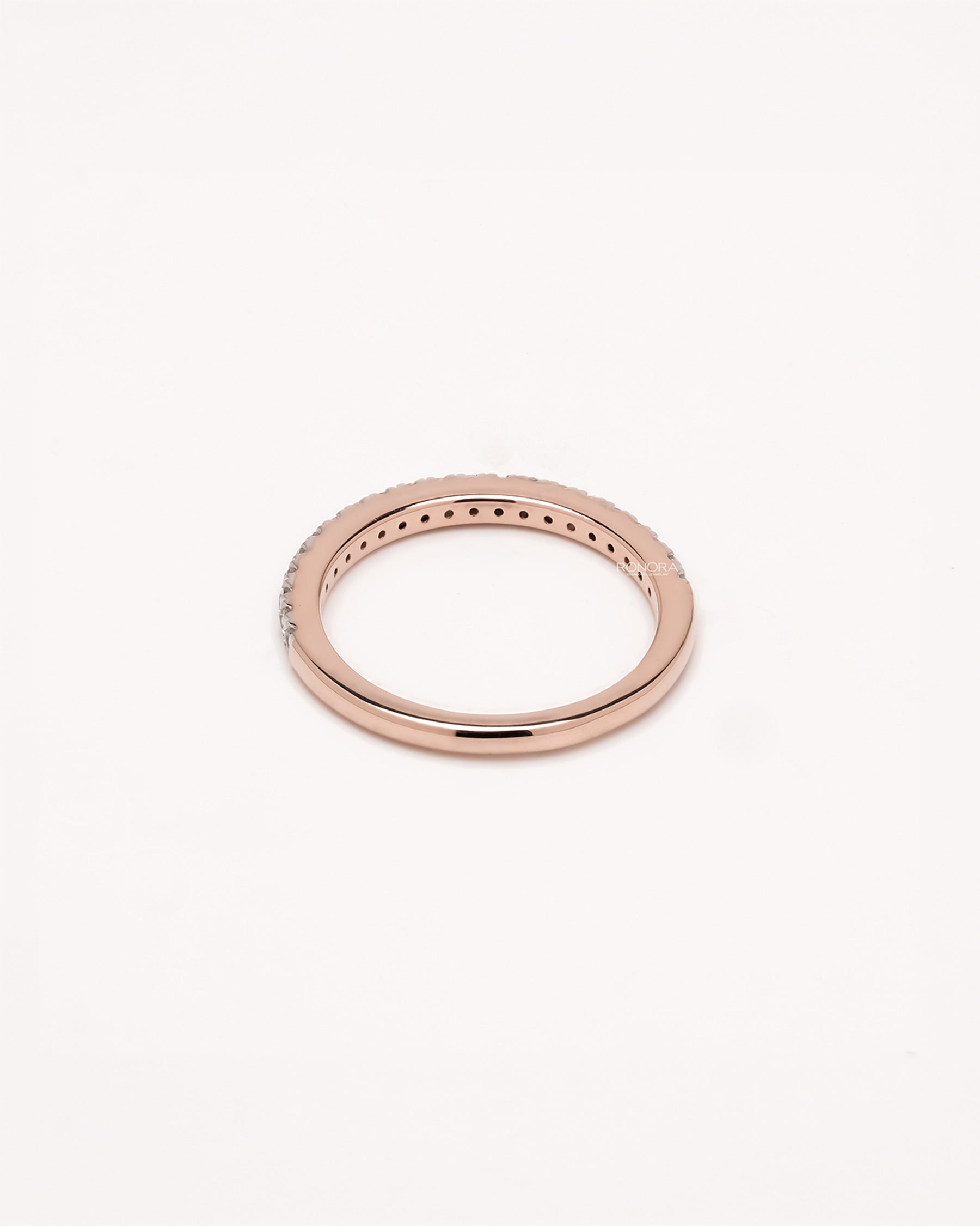 Side profile of slim curved lab grown diamond pavé band showing pavé setting