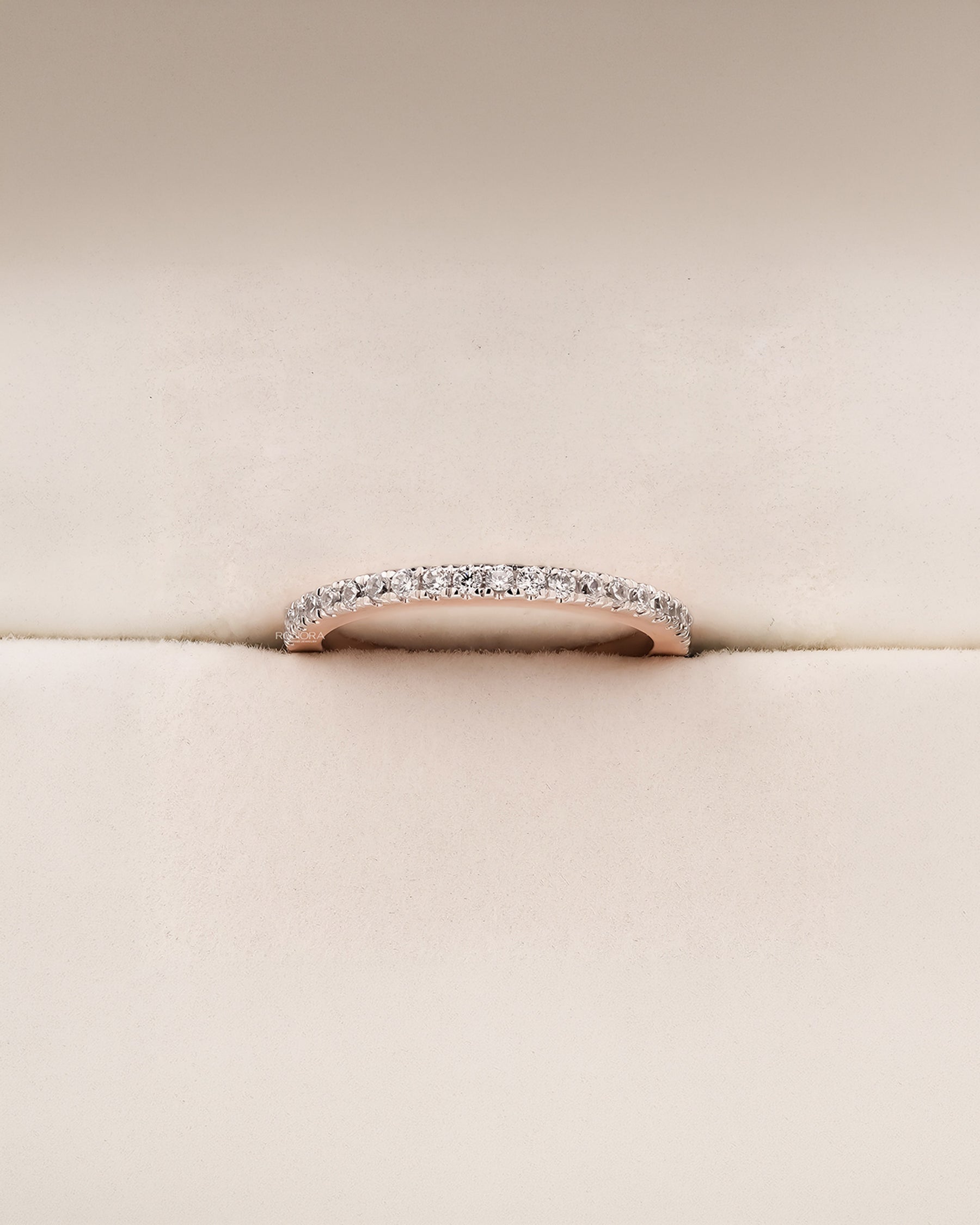 Angled view of slim curved lab grown diamond pavé band showing pavé setting