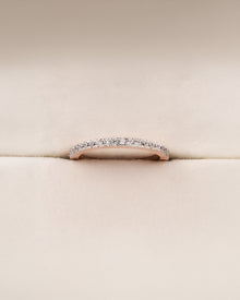 Angled view of slim curved lab grown diamond pavé band showing pavé setting