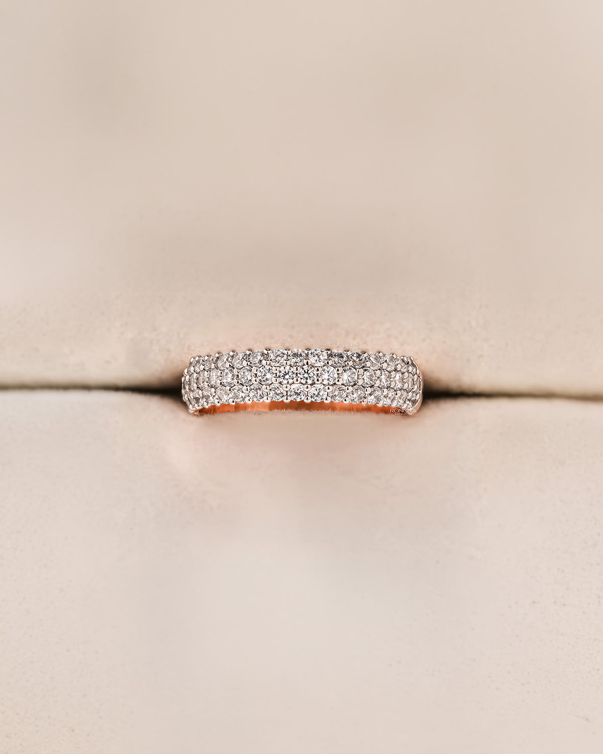 Angled view of wide lab grown diamond pavé band showing multi-row pavé setting