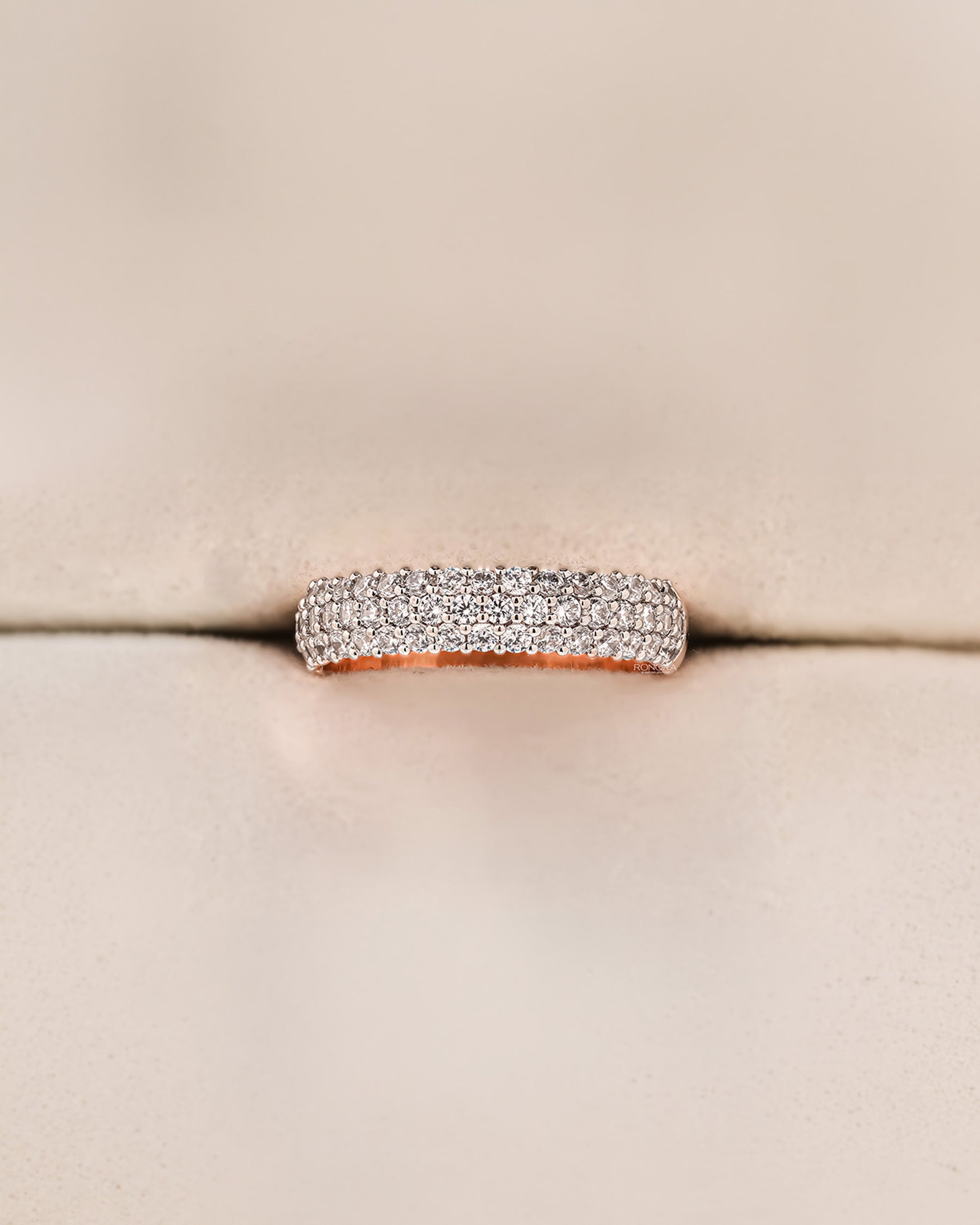 Angled view of wide lab grown diamond pavé band showing multi-row pavé setting