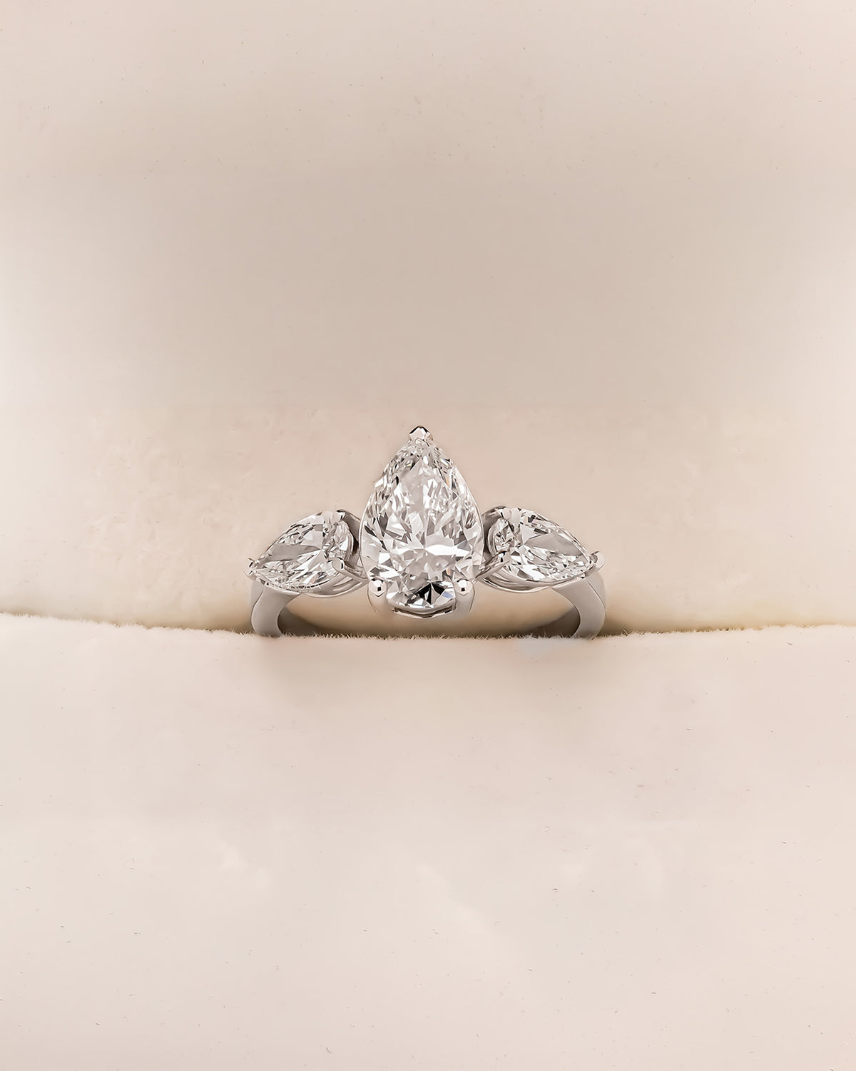 Ophelia pear lab grown diamond three-stone ring in white metal inside Ronora box