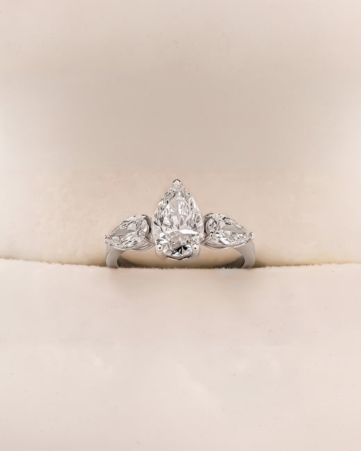 Ophelia pear lab grown diamond three-stone ring in white metal inside Ronora box