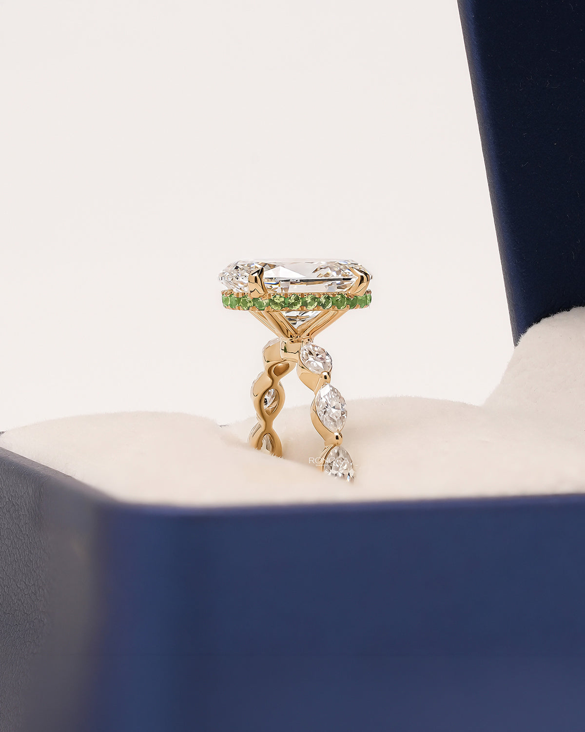 Side profile of oval marquise lab grown diamond three-stone ring showing ornate three-stone setting