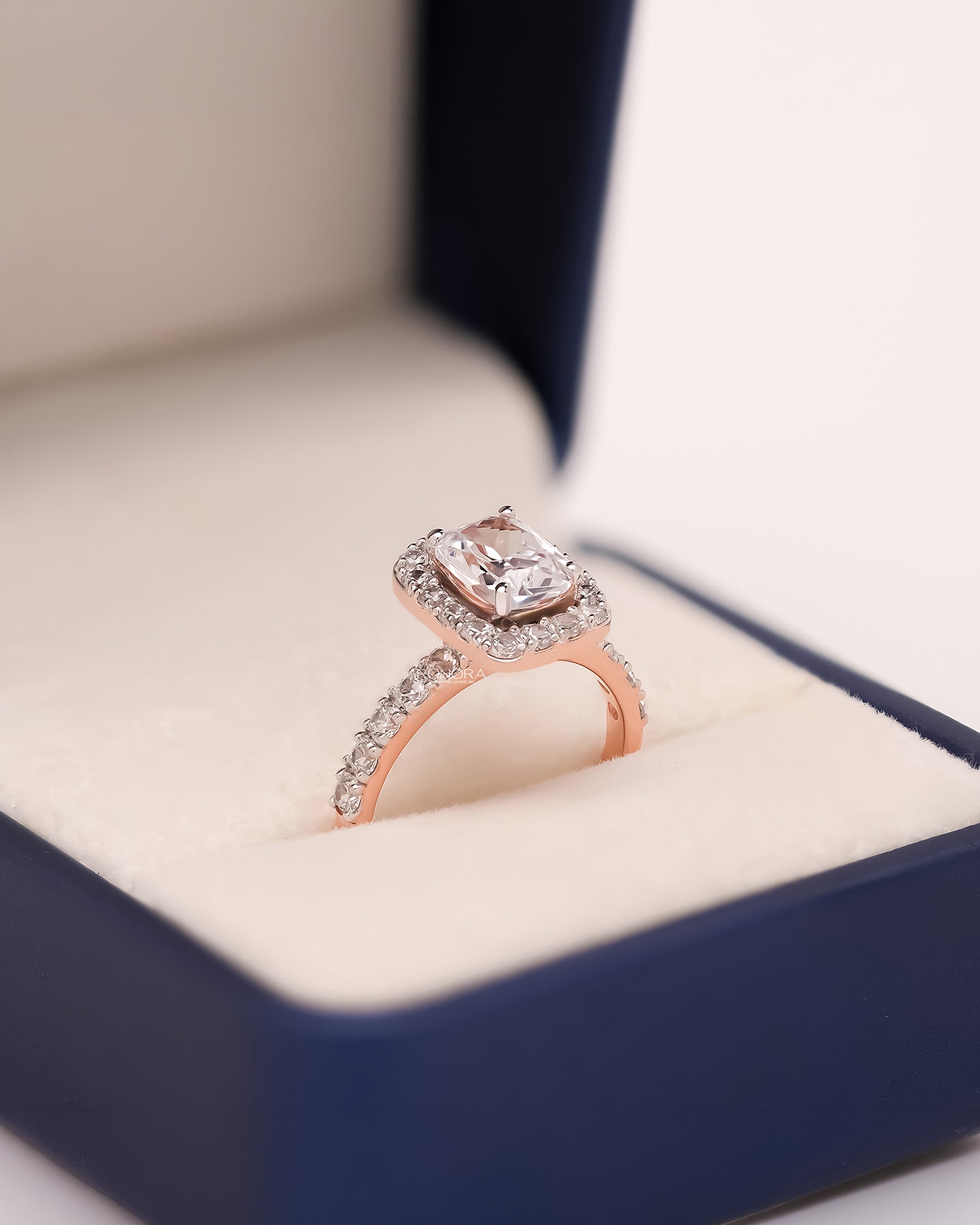 Angled view of cushion moissanite halo ring showing halo pavé setting