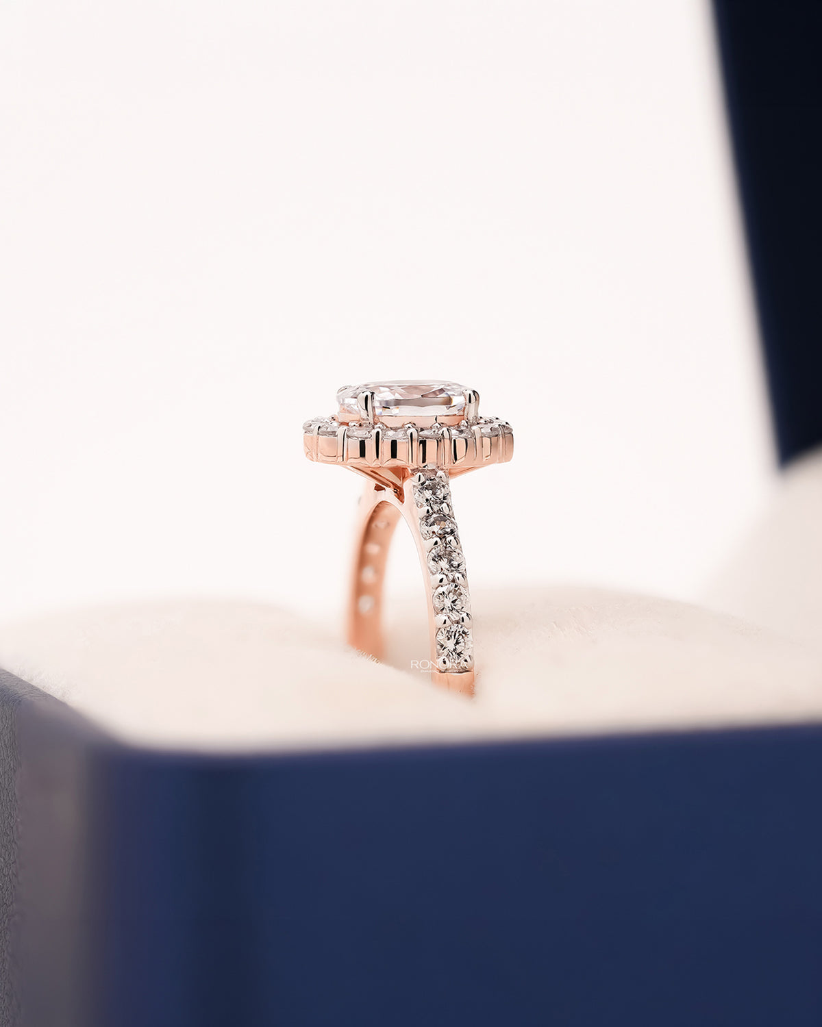 Side profile of cushion moissanite halo ring showing halo pavé setting