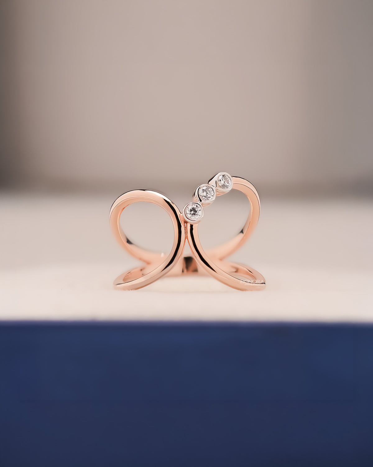 Seren open lab grown diamond swirl ring in rose gold inside Ronora box
