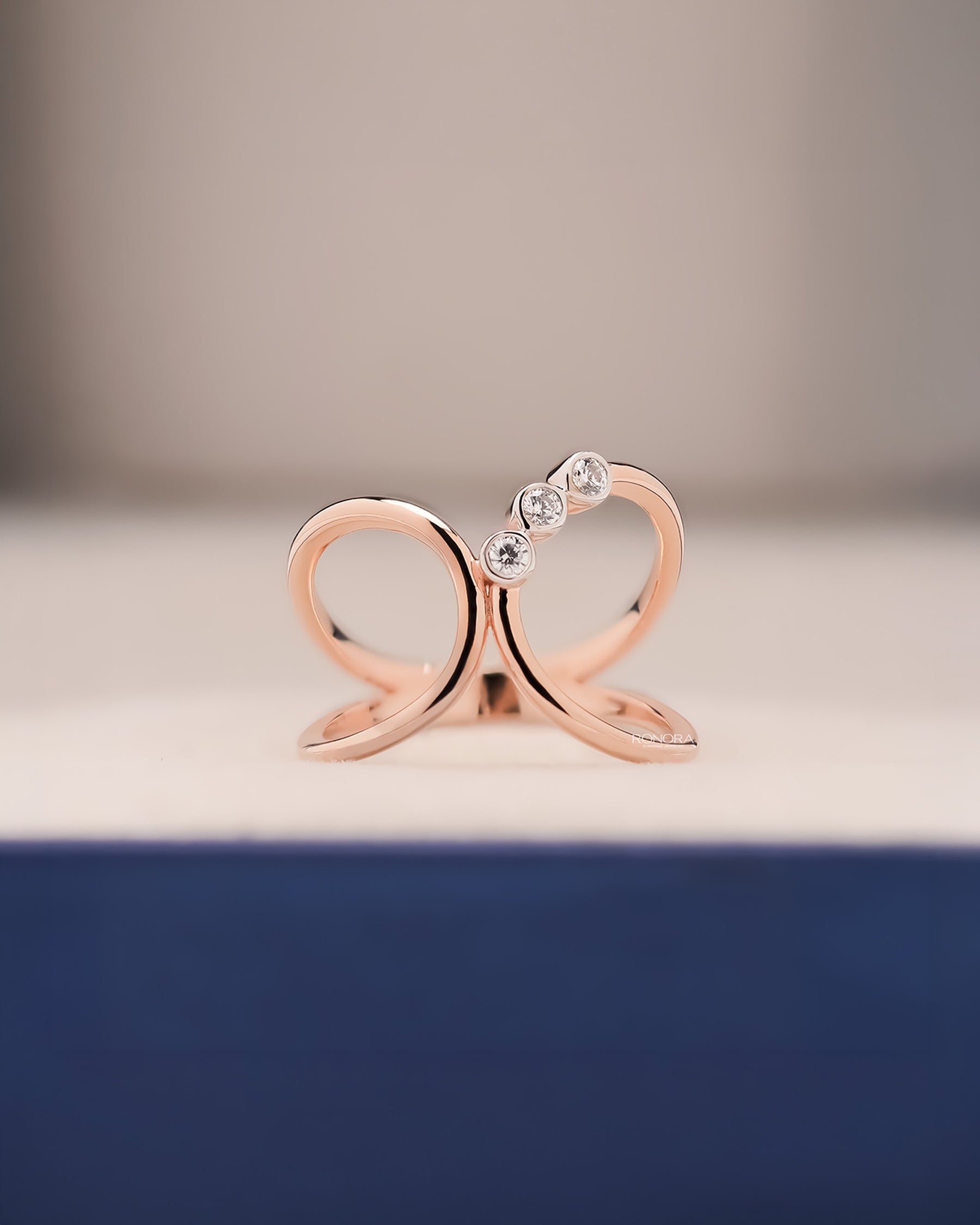 Seren open lab grown diamond swirl ring in rose gold inside Ronora box