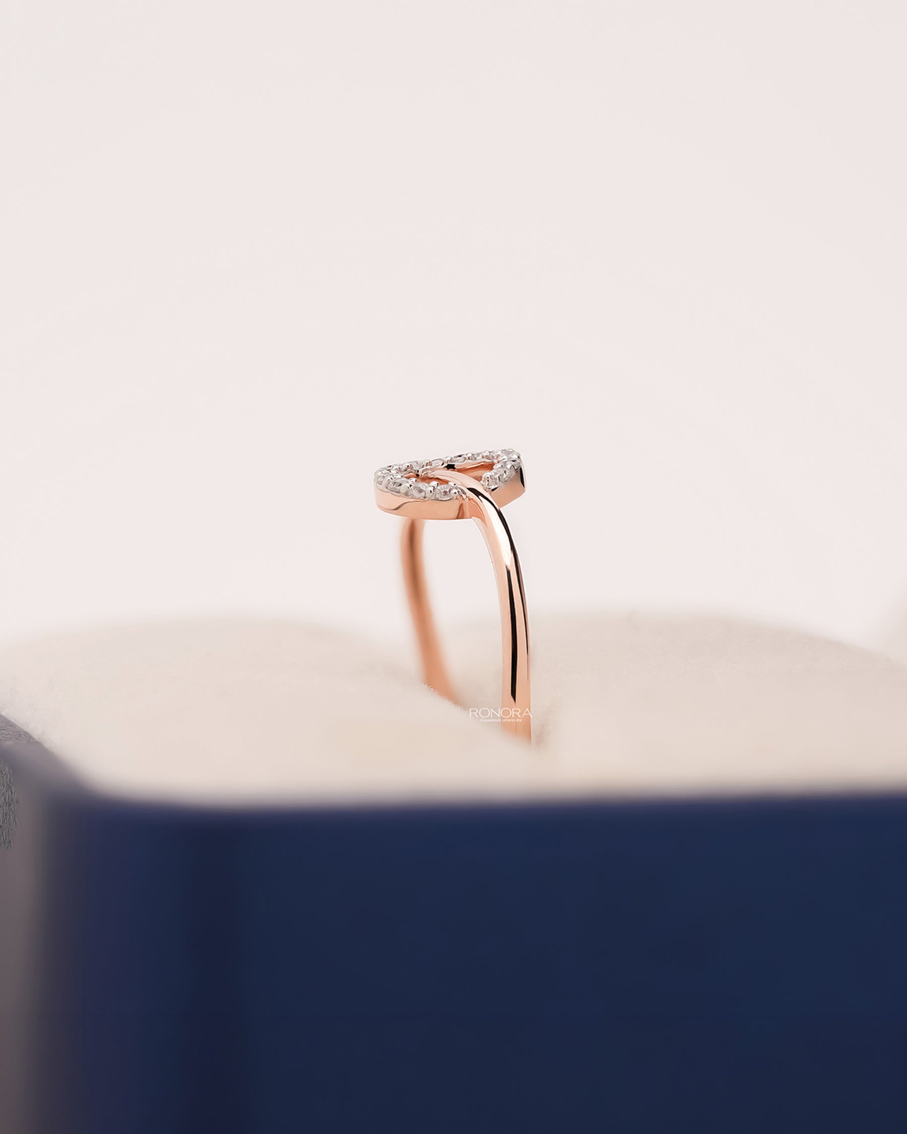 Side profile of round lab grown diamond bypass ring in Ronora box