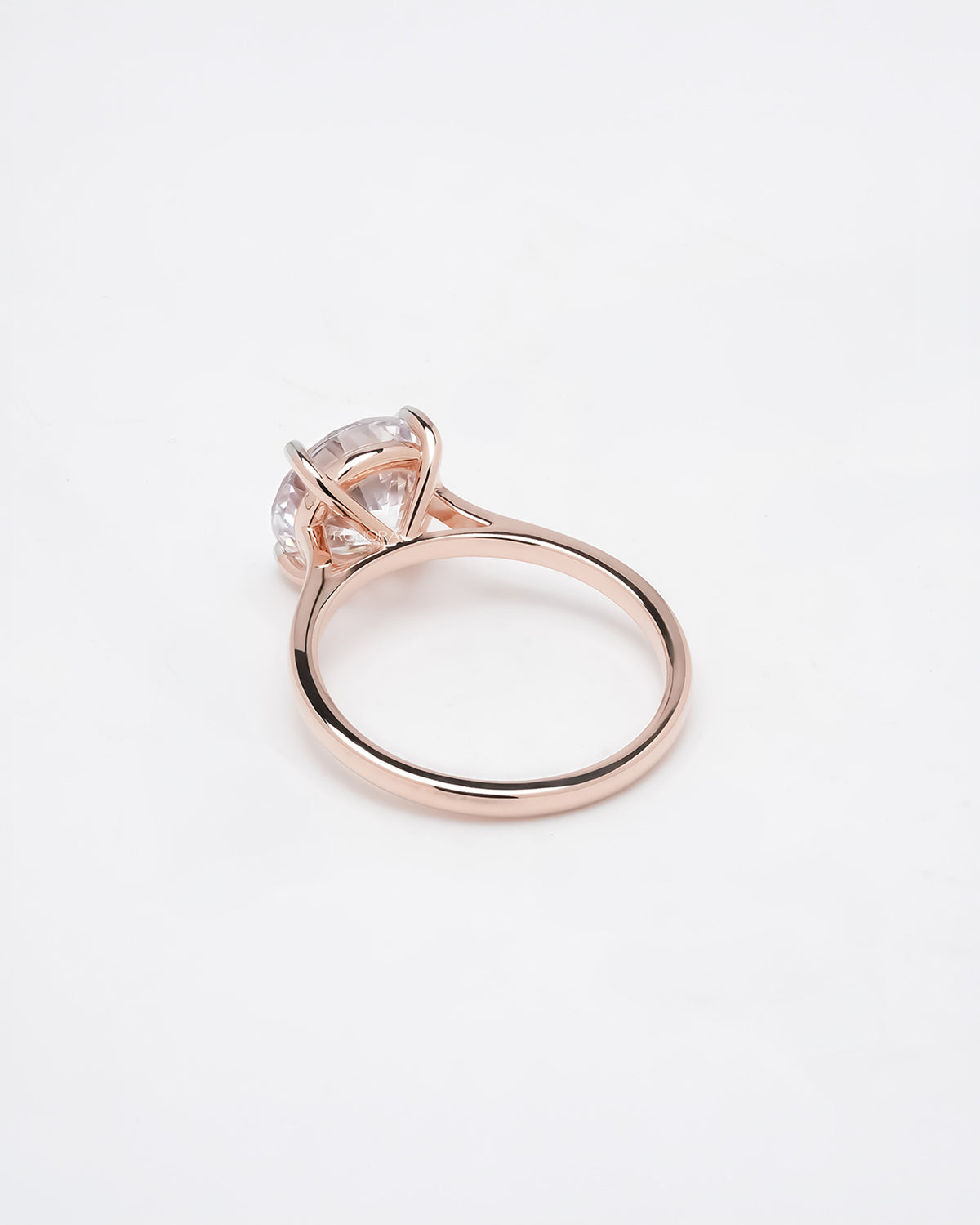 Back view of round moissanite solitaire ring showing slim rose gold band