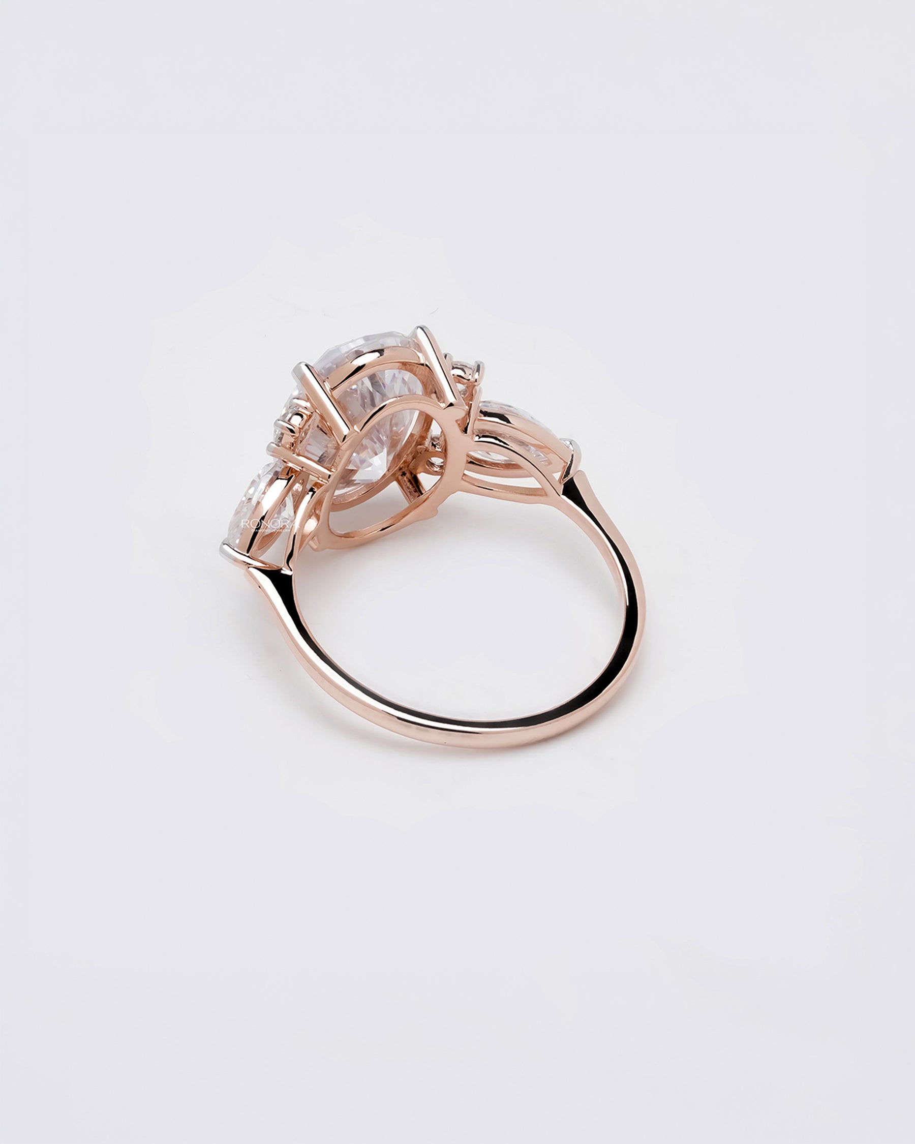 Back view of oval moissanite three-stone ring showing gallery and band
