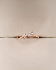 Angled view of marquise lab grown diamond curved ring with curved band setting