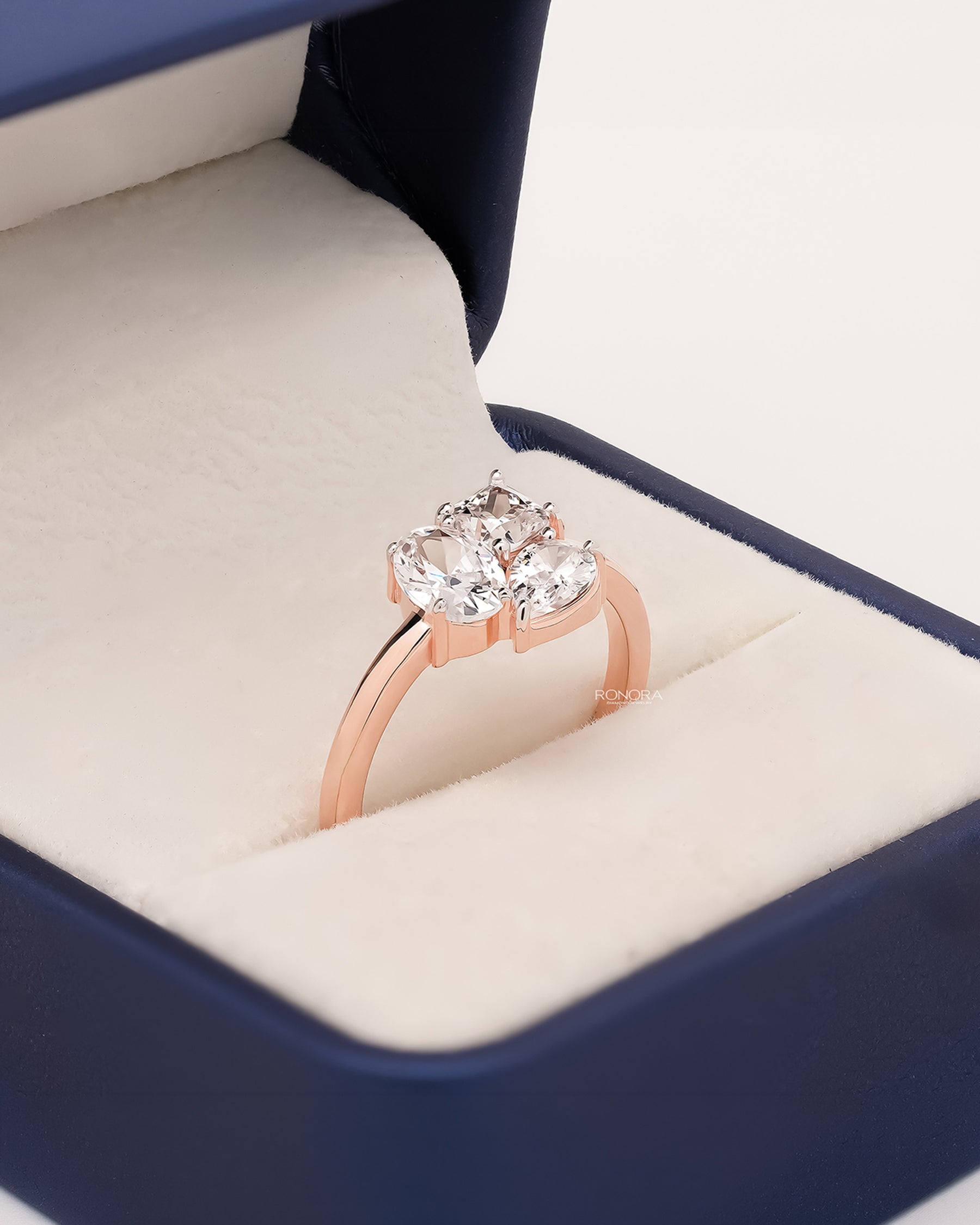 Angled view of oval lab grown diamond cluster ring with cluster setting