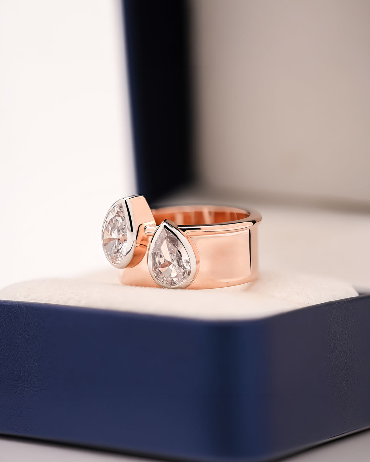 Angled view of pear lab grown diamond bypass ring with bypass setting