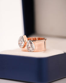 Angled view of pear lab grown diamond bypass ring with bypass setting