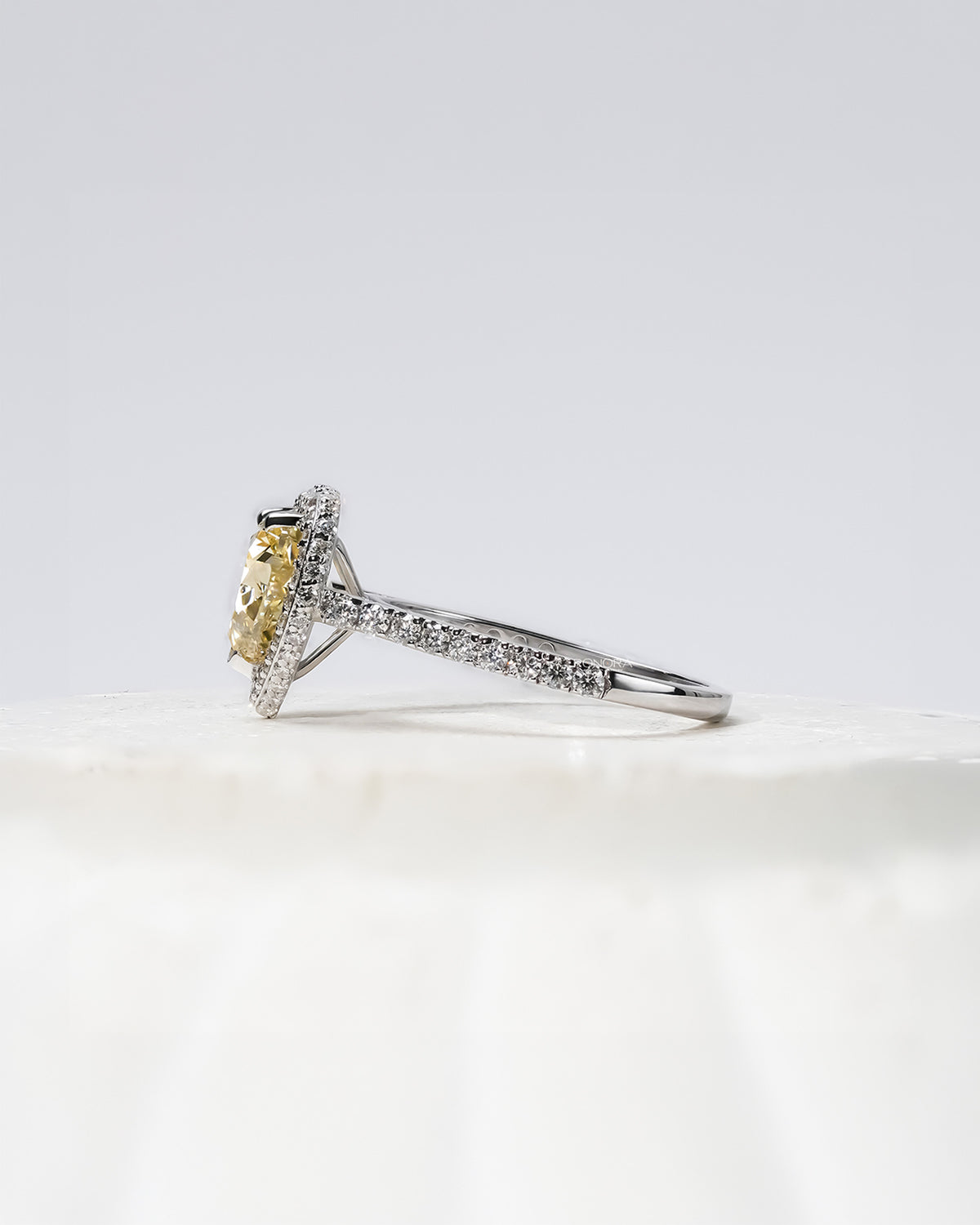yellow heart lab grown diamond halo ring worn with luxury styling in white gold