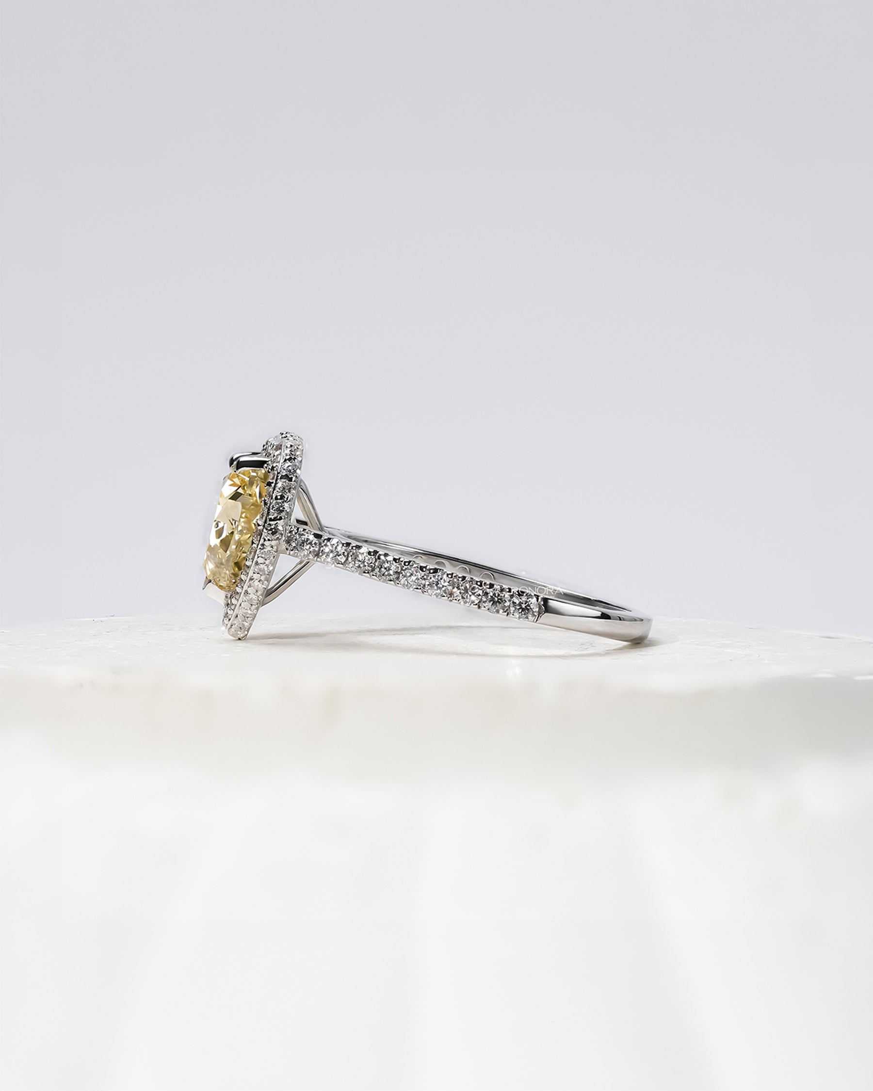 yellow heart lab grown diamond halo ring worn with luxury styling in white gold