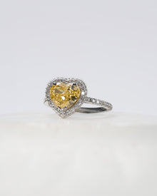 Angled view of yellow heart lab grown diamond halo ring with halo setting