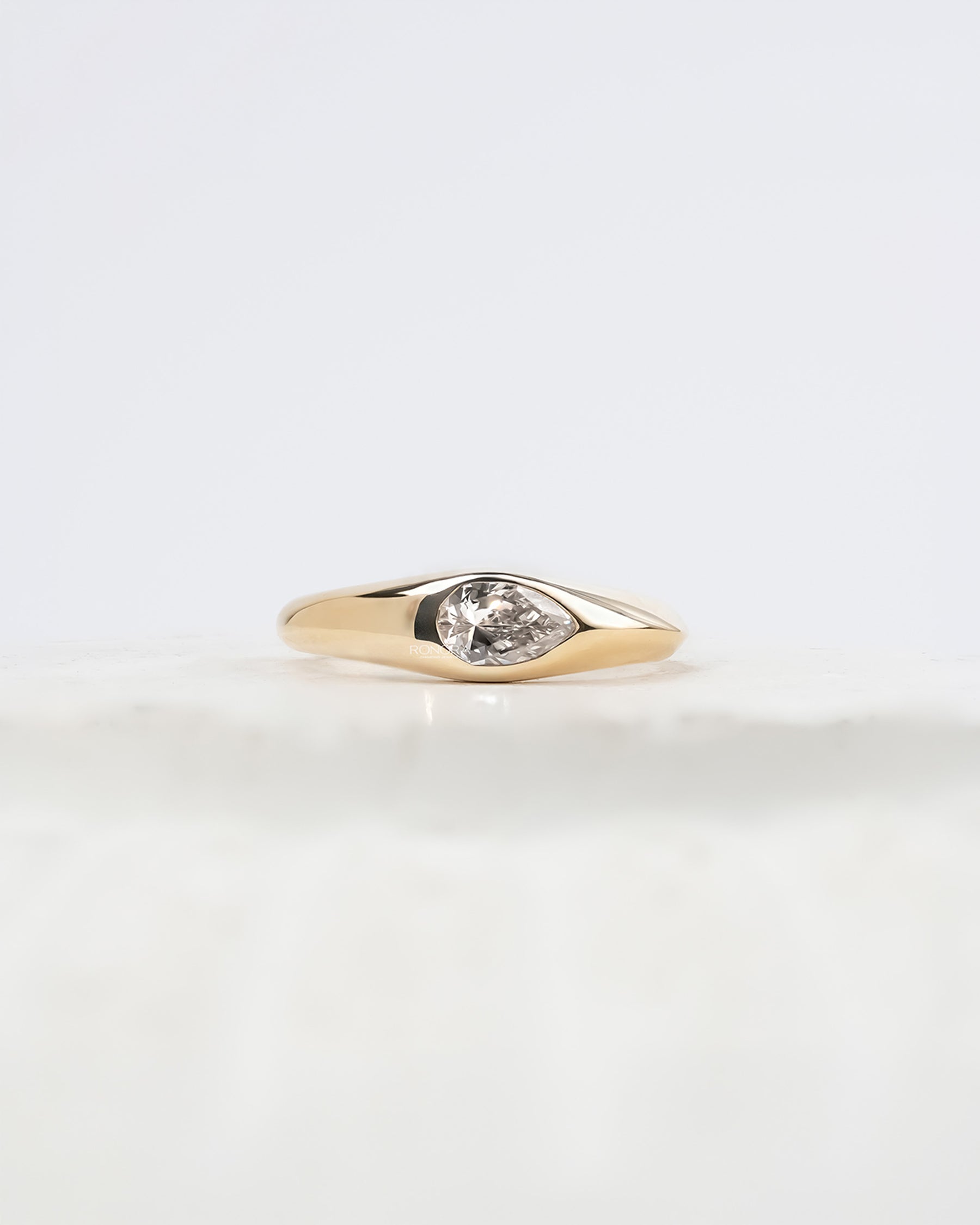 Mabelle pear lab grown diamond bezel ring in yellow gold inside Ronora box