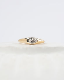 Mabelle pear lab grown diamond bezel ring in yellow gold inside Ronora box