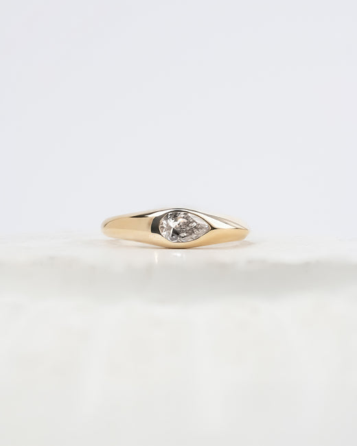 Mabelle pear lab grown diamond bezel ring in yellow gold inside Ronora box