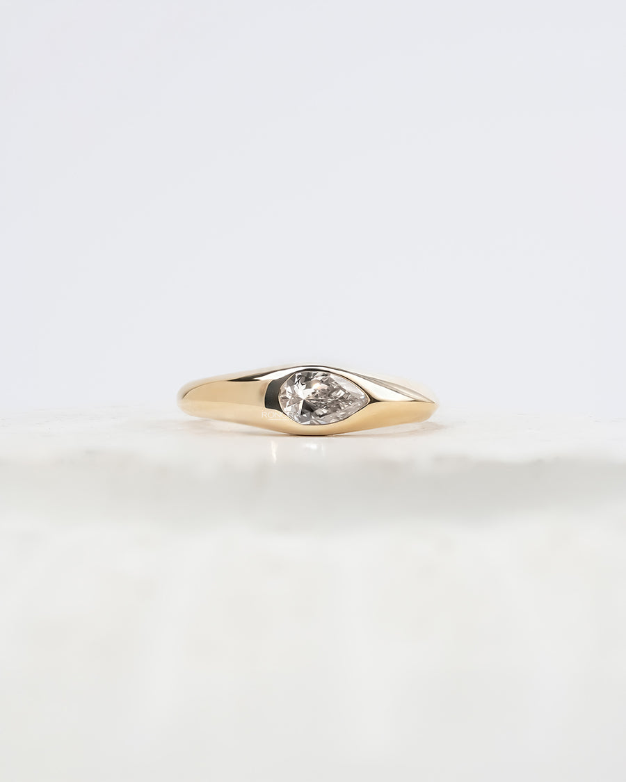 Mabelle pear lab grown diamond bezel ring in yellow gold inside Ronora box