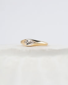 Angled view of pear lab grown diamond bezel ring with bezel setting