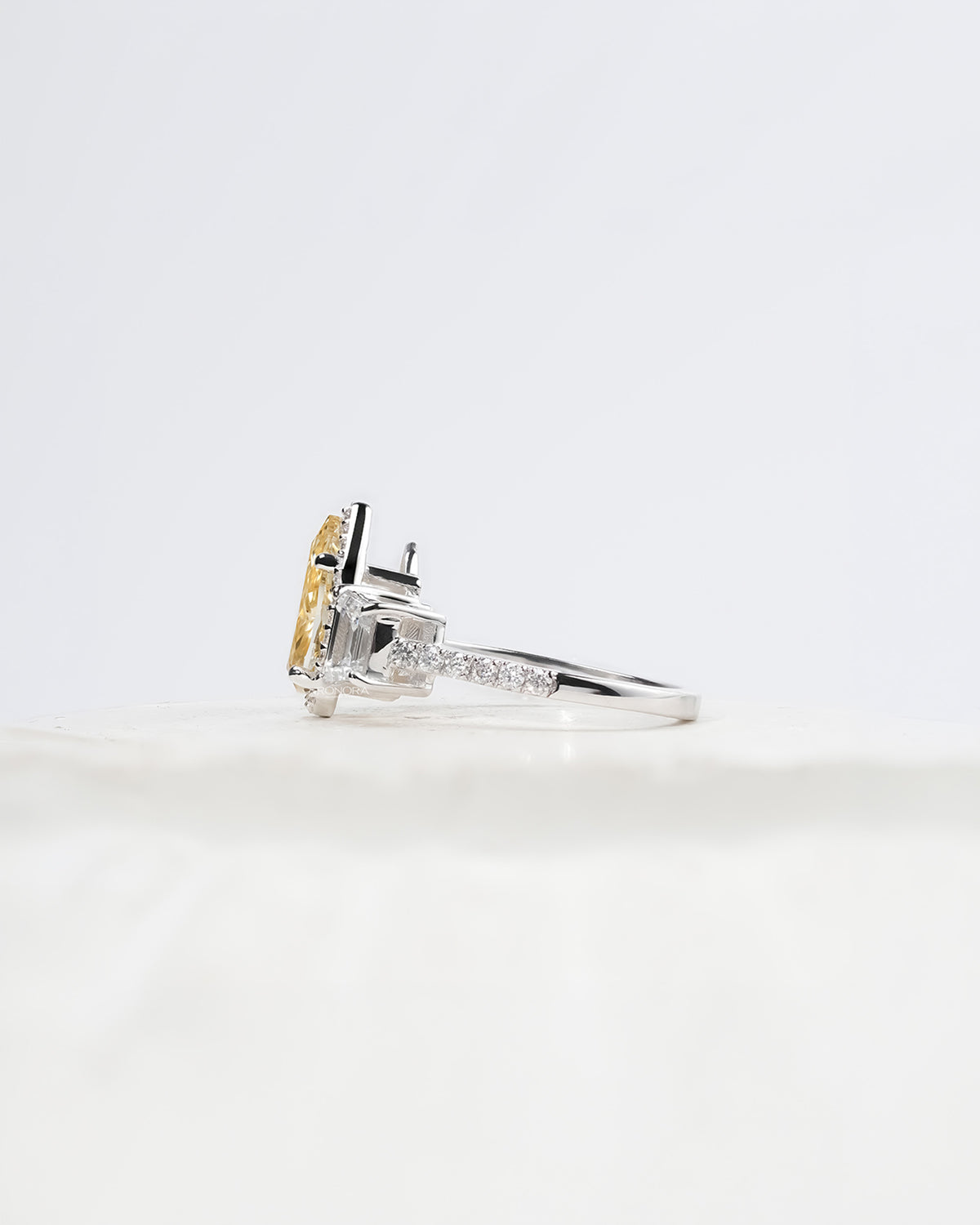 Side profile of yellow pear lab grown diamond halo ring showing ring setting