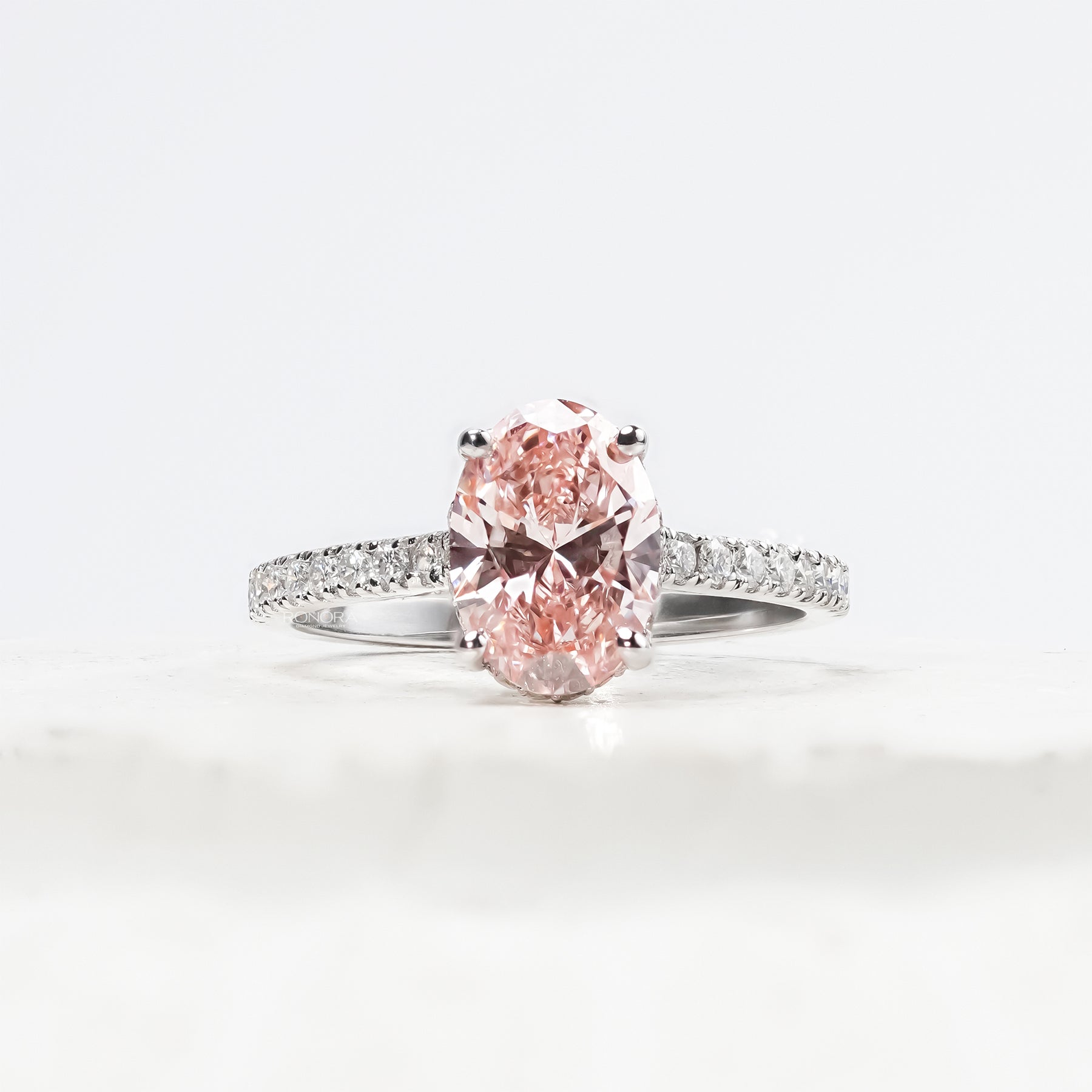 Rosalie pink oval lab grown diamond halo ring in white gold inside Ronora box