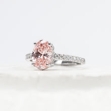 Angled view of pink oval lab grown diamond halo ring with halo pave setting