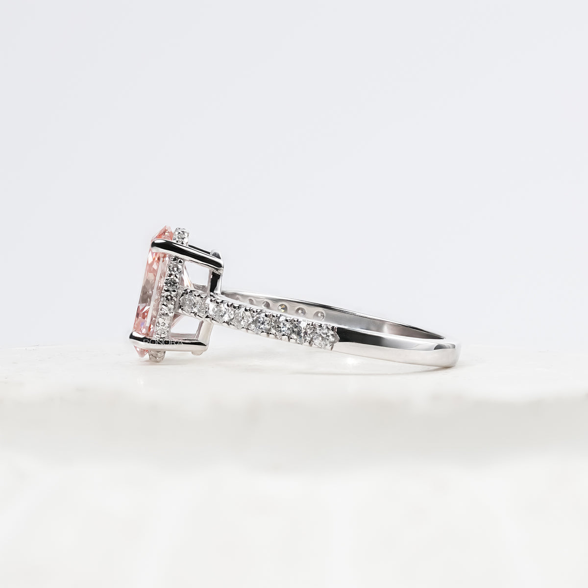 pink oval lab grown diamond halo ring worn with luxury styling in white gold