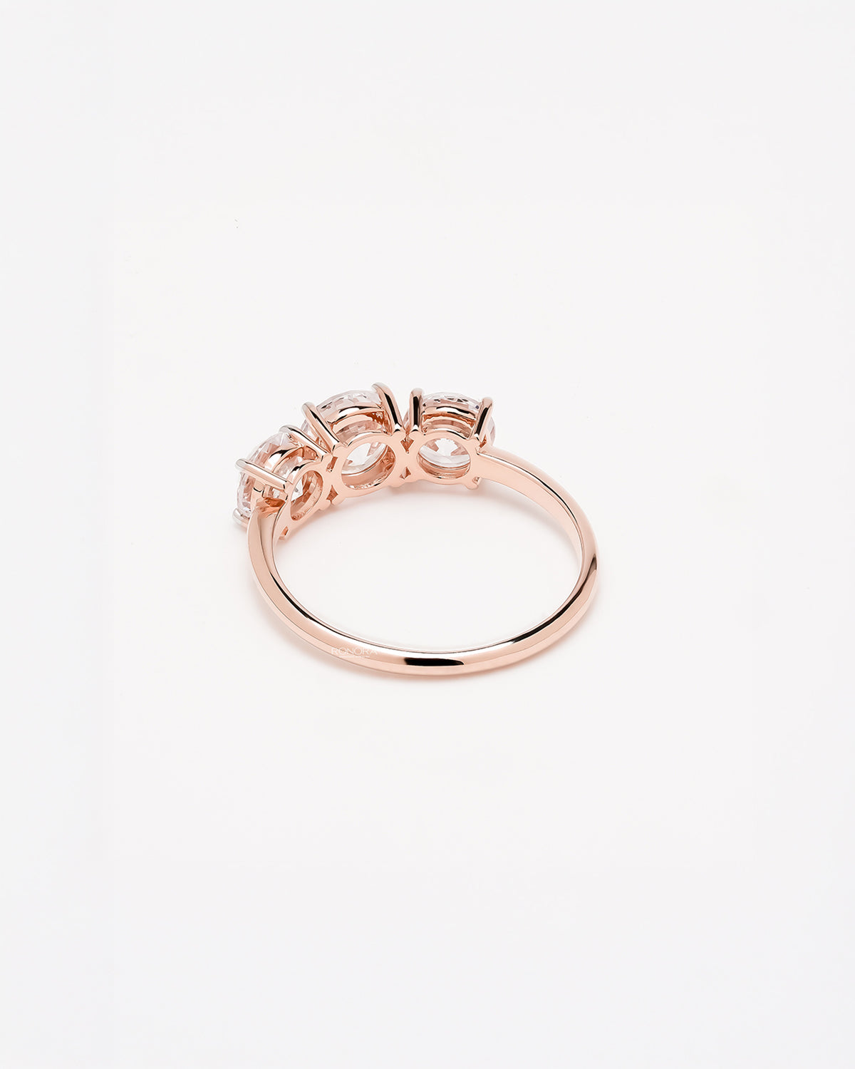 Back view of round lab grown diamond three-stone ring showing band detail
