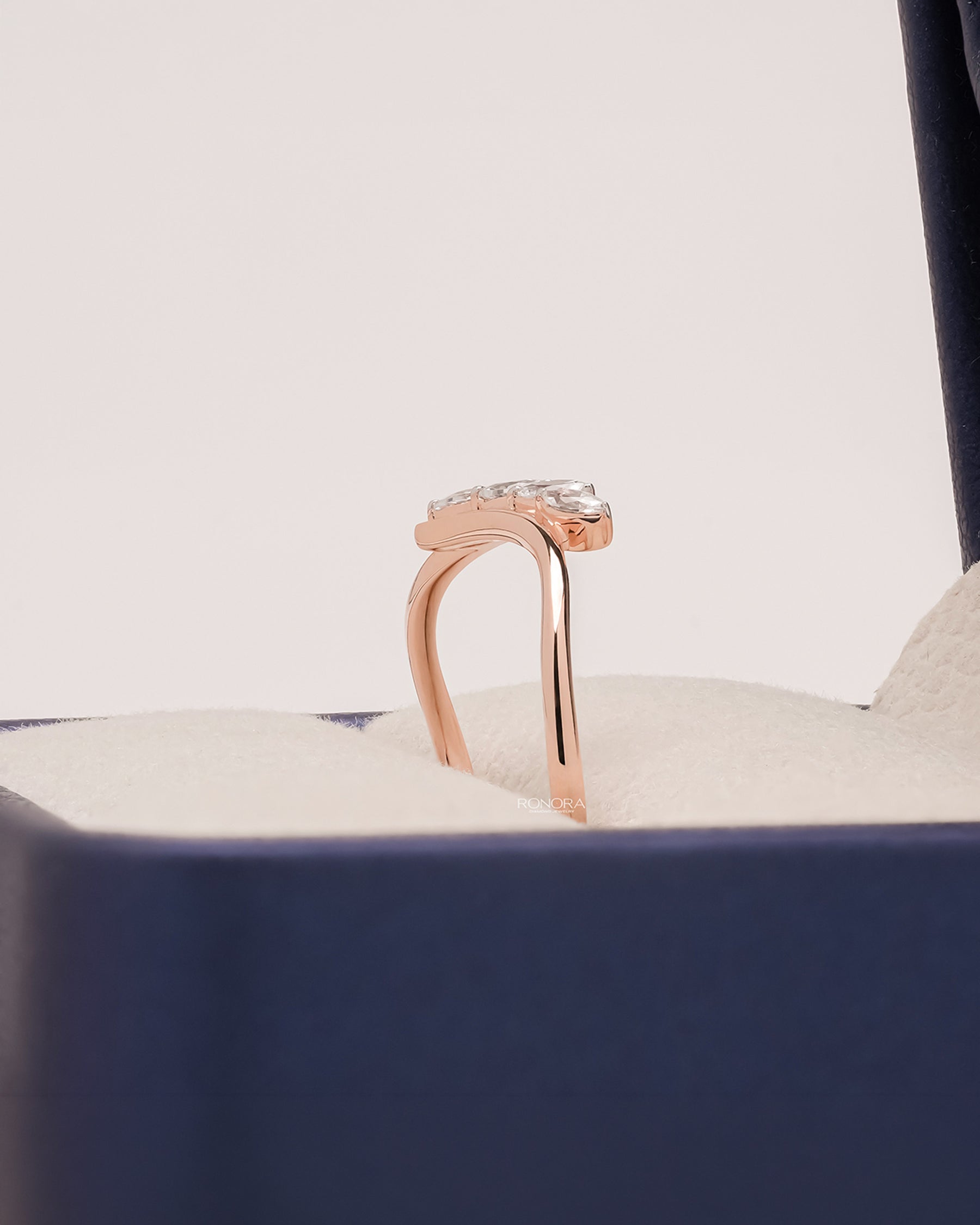 Side profile of marquise lab grown diamond curved ring showing ring setting