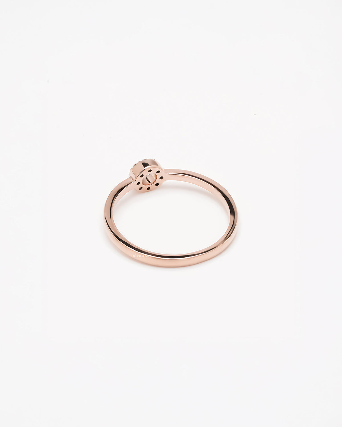 Back view of round lab grown diamond halo ring showing slim rose gold band