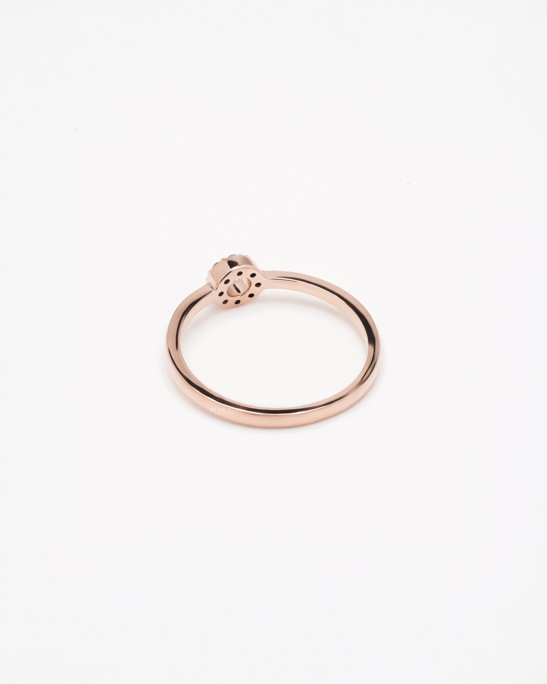 Back view of round lab grown diamond halo ring showing slim rose gold band