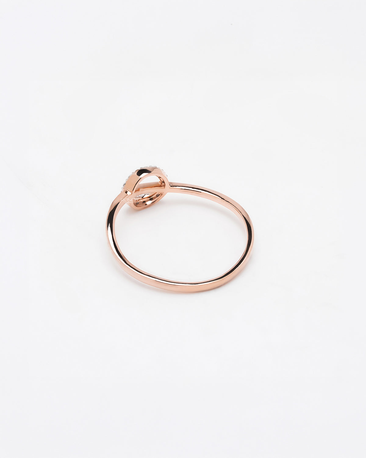 Back view of round lab grown diamond bypass ring showing slim rose gold band