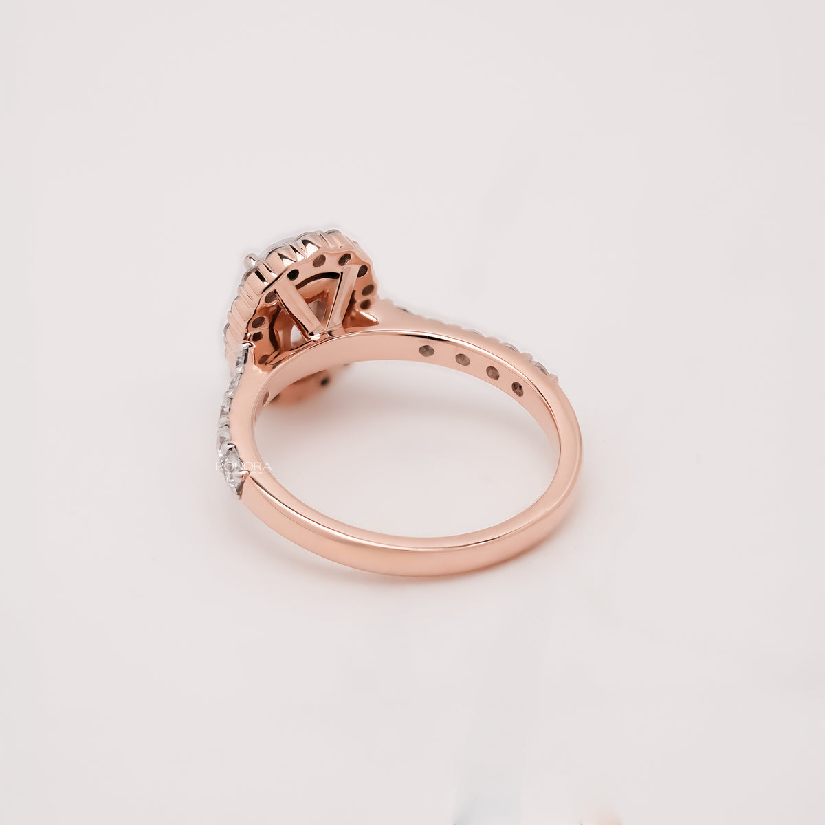 oval moissanite halo ring worn with luxury styling in rose gold