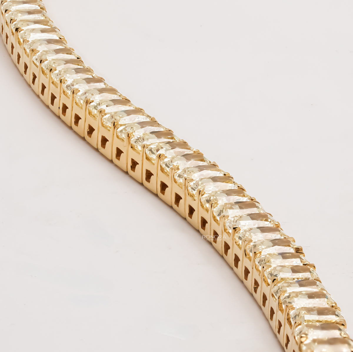 Close-up row view of radiant yellow lab grown diamond tennis bracelet